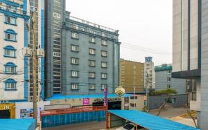 a large building with a blue ramp in a city at Chakan Hotel in Gunsan