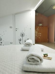 a room with two beds with towels on them at Ferula loft in Sortino