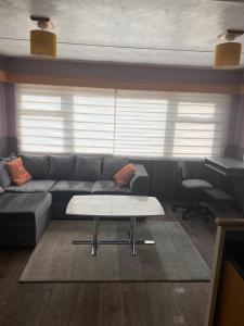 a living room with a couch and a table at Family or couple 3-bed cosy home with fireplace, 50 deposit required, self-catering in Hastings