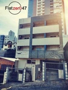 a tall building with a gate in front of it at Flatzer047 Executivo in Caxias do Sul