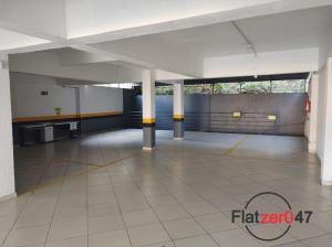 a large empty parking garage with columns and ailed floor at Flatzer047 Executivo in Caxias do Sul