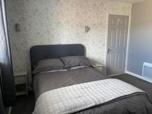 a bedroom with a bed with two pillows on it at Kevara Self-Catering in Finstown