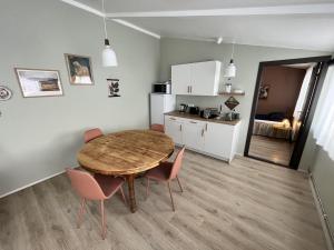a kitchen and dining room with a table and chairs at Bridge Apartment in Egilsstaðir
