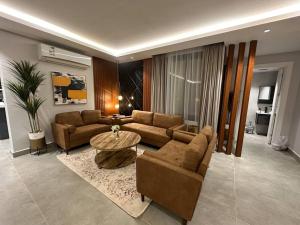a living room with a couch and a table at ROSE RESIDENCE I Luxury 3BR Apartment I North Riyadh in Riyadh
