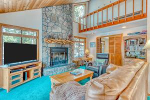 a living room with a couch and a fireplace at The Huckleberry Cabin in Sunriver