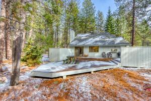 a house in the woods with a patio at The Huckleberry Cabin in Sunriver