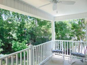 a porch with two chairs and a ceiling fan at E10 comfortable and neat 2 bedroom 2 bath in Saint Simons Island