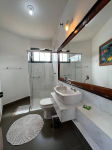 a bathroom with a sink and a toilet and a shower at Cama e Café Tiradentes in Tiradentes +49 photos
