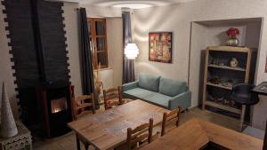 sala de estar con mesa, silla y sofá en La Salabertie en Bagnac