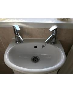 a white sink with two faucets in a bathroom at 31 Queens Road in Winchester
