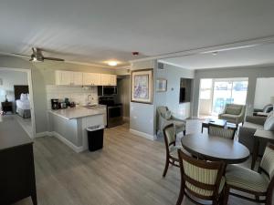 a living room and kitchen with a table and chairs at Marco Island Lakeside Inn in Marco Island