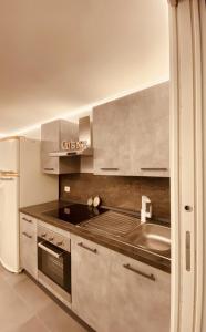 a kitchen with a sink and a refrigerator at Dimora Falcone in Bari