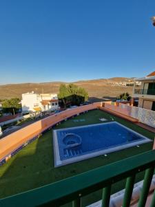 a swimming pool on the roof of a building at TaraVilla in Tarajalejo