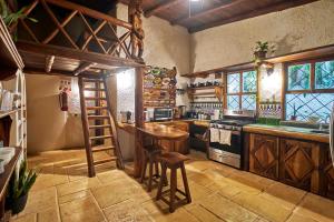 a kitchen with a wooden table and a stove at Villa Havana in Mal País
