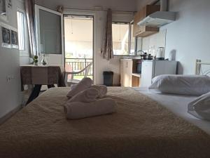 a room with two beds with towels on top of it at Christos Family Apartments Β in Ágios Rókkos