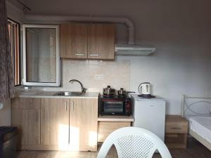 a small kitchen with a sink and a microwave at Christos Family Apartments Β in Ágios Rókkos +6 photos