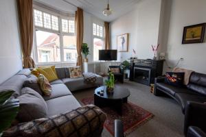 a living room with a couch and a fire place at City House Hoorn in Hoorn