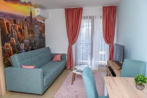 a living room with a couch and a table at Flatiron Apartments Skopje in Skopje