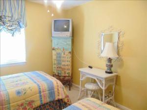 ein Schlafzimmer mit einem Bett, einem Tisch und einem Spiegel in der Unterkunft N5 great for families 4 twins 1 king, screened room large living room 2 and 1 half baths bedromms up in Mallory Park