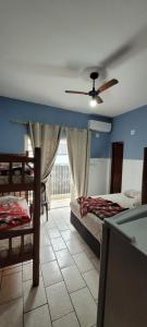 a bedroom with two beds and a ceiling fan at Hotel, Pousada e Restaurante Estrela Azul in Aparecida