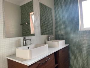 ein Badezimmer mit einem weißen Waschbecken und einem Spiegel in der Unterkunft Casa da Várzea - O Castelo à Janela!!! in Óbidos