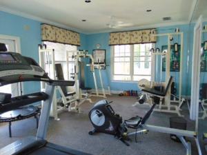 a room with a gym with exercise equipment in it at T11 Downstairs King Bed Ocean Walk Resort close to tennis courts and back pool in Mallory Park