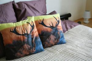 2 almohadas con cuernos de ciervo en una cama en Maison Marigoule - Perfect with kids & families, en Mialet