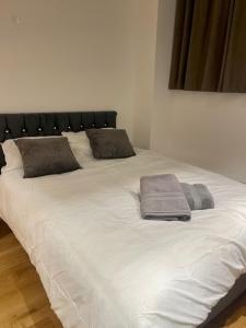 a large white bed with two pillows on it at Monument Prime Location in the City of London in London