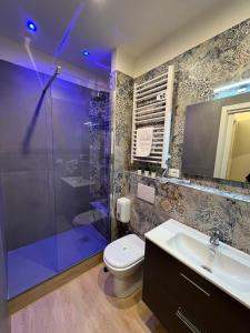 a bathroom with a shower and a toilet and a sink at La Suite Rooms & Apartments in Bologna