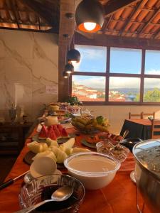 a long table with many plates of food on it at Pousada da Seresta in Diamantina