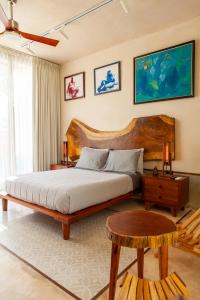a bedroom with a large wooden bed and a table at La Parcela Cunkal in Conkal