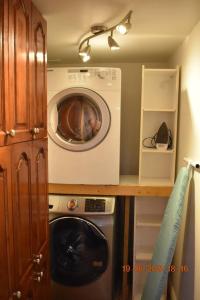 a laundry room with a washer and a washing machine at Lovely private one bedroom apartment in Kanata in Ottawa