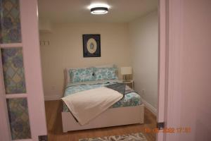 a small bedroom with a bed in a room at Lovely private one bedroom apartment in Kanata in Ottawa