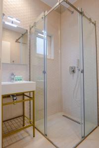 a bathroom with a shower and a sink at Otto Hotel in Ksamil