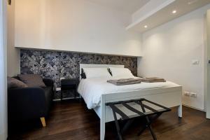 a bedroom with a bed and a desk and a chair at Suite in Town in Bologna