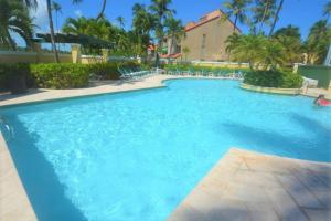 a large pool with blue water in a resort at Beachfront Getaway for two! in Humacao