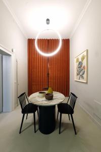 a dining room with a table with chairs and a light at Casa Caleido in Verona