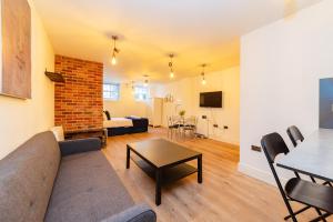 a living room with a couch and a table at MORDEN STUDIO CENTRAL BRIGHTON LOCATION Sleep 3 Guests in Brighton & Hove