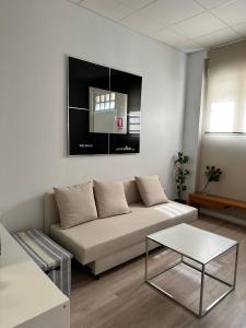 a living room with a couch and a table at Apartamento tipo loft valencia in Paiporta