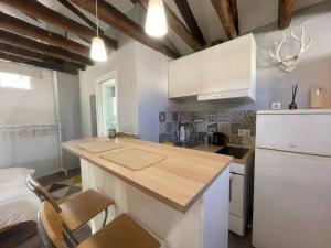 a kitchen with white cabinets and a counter top at Punta Me Beautiful Apartment in Plaza España in Madrid