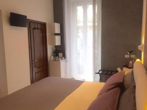 a bedroom with a bed and a large window at Correa Vatican Hospitality in Rome