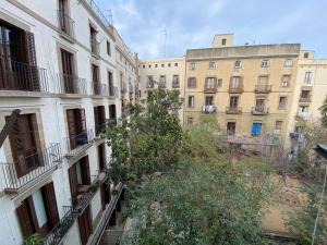 a group of buildings with trees in between them at Lovely 2-Bed Apartment in Barcelonas best location in Barcelona