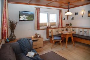 a living room with a couch and a table at Ferienhaus Hochvogel in Hinterhornbach