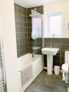 a bathroom with a sink and a tub and a toilet at Arcaro house in Andover