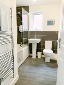 a bathroom with a toilet and a sink at Arcaro house in Andover