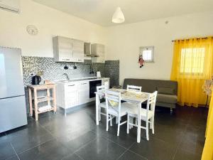 a kitchen and living room with a table and a couch at CASA DANI in Tarquinia