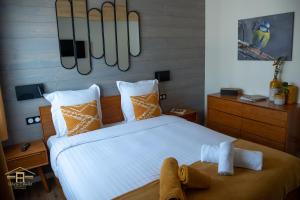 a bedroom with a large bed with orange and white pillows at NOTRE CHALET - Boutique Hôtel - En couple - En famille - En groupe in Les Fourgs