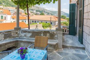 a table and chairs on a balcony with a view at Apartment& Room Lukre / Apartment Lukre with terrace in Dubrovnik