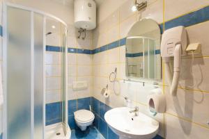 a bathroom with a toilet sink and a shower at Apartment& Room Lukre / Apartment Lukre with terrace in Dubrovnik