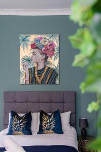 a painting of a woman with flowers on a bed at Stunning STUDIO Apartment in Hove Minuets away to BRIGHTON BEACH in Brighton & Hove